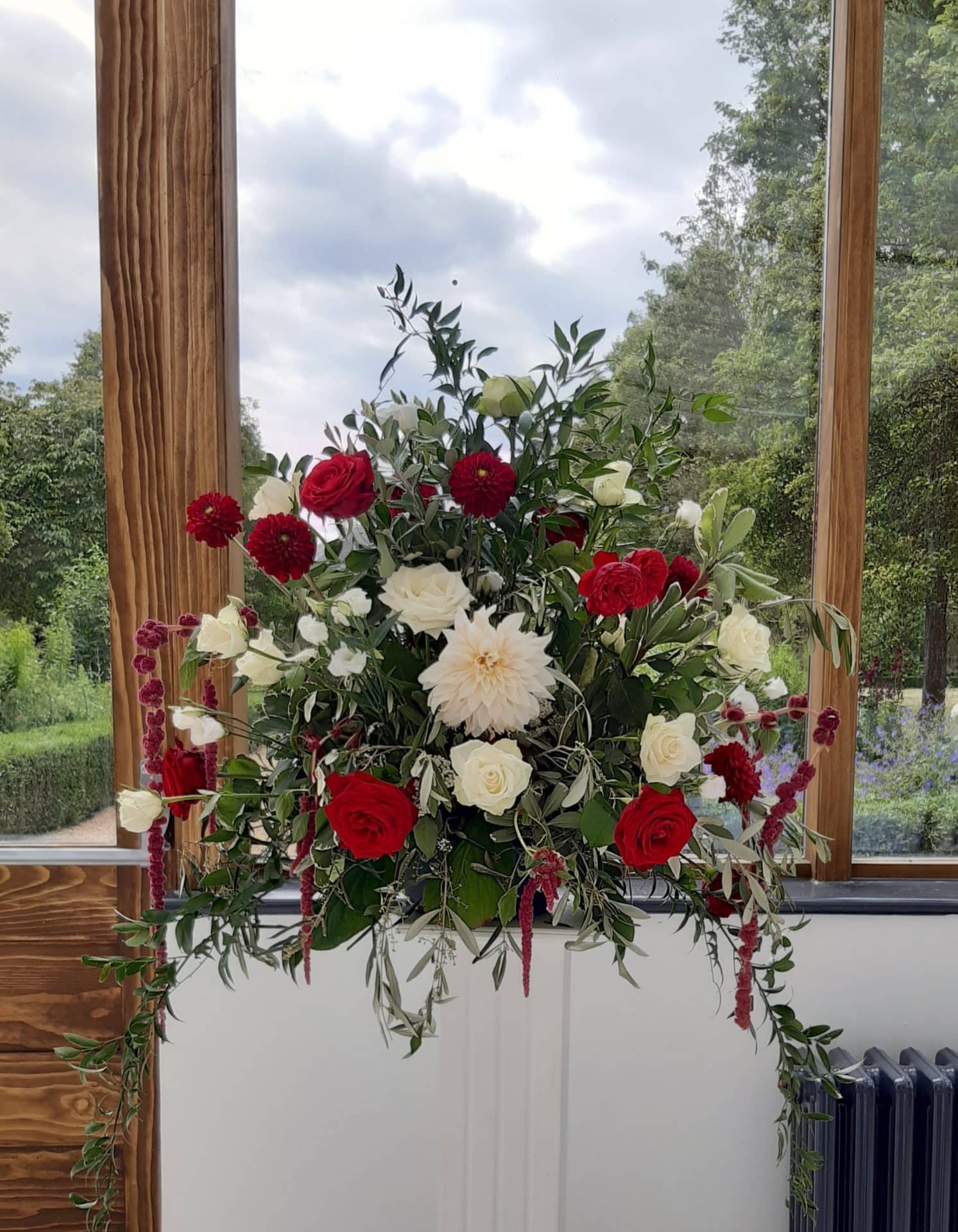 Red and White Flower arrangement on a pedestal